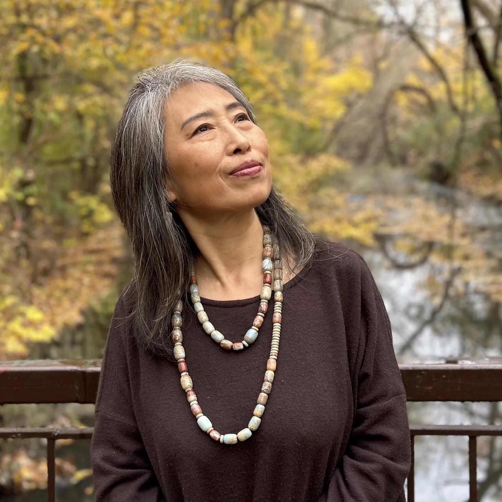 Portrait of Zhu Dandan outdoors.